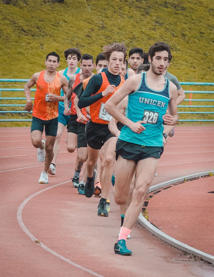 pexels photo 15292660 Group of male athletes in a race on an outdoor track, showcasing speed and competition.
